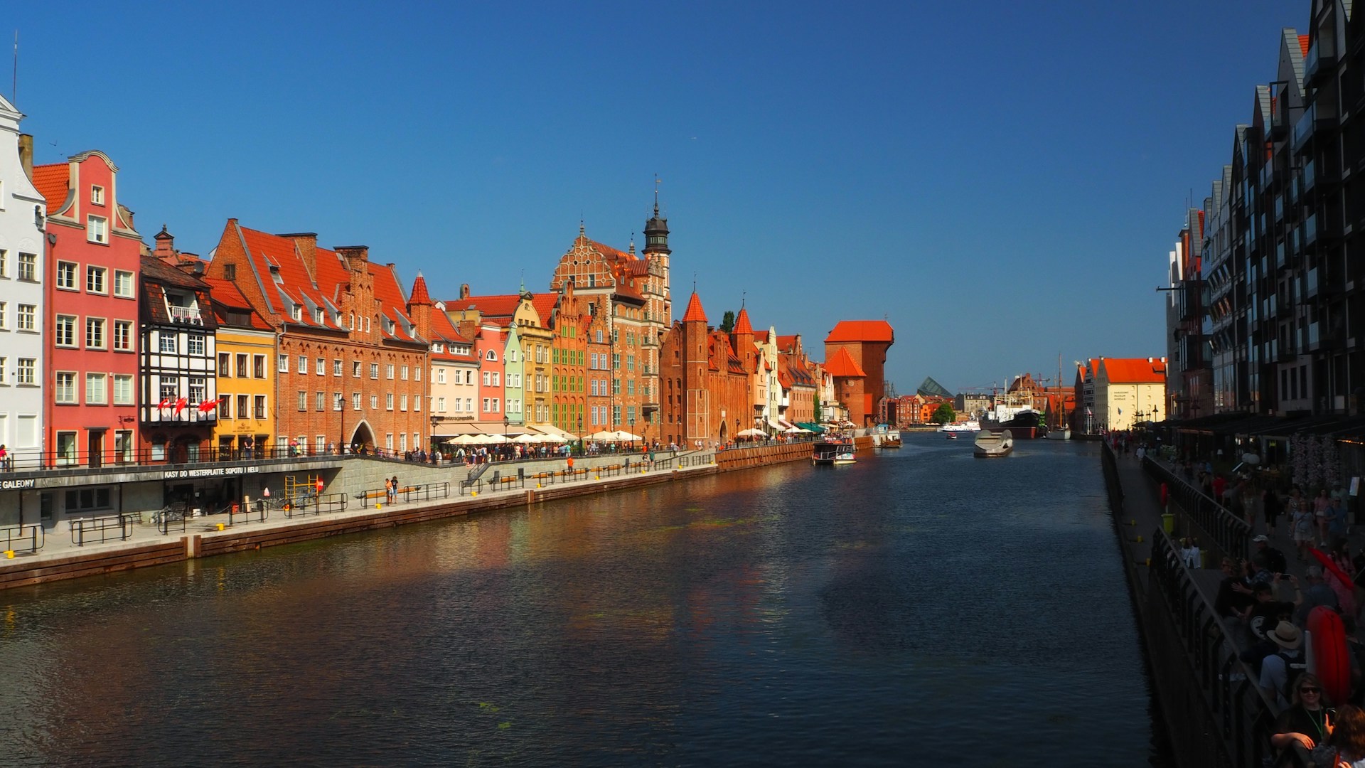 Colorful merchant houses along the Motlawa River in Gdansk's Old Town at sunset
